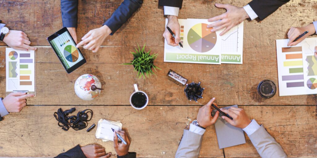 Business people sat round the table in a meeting